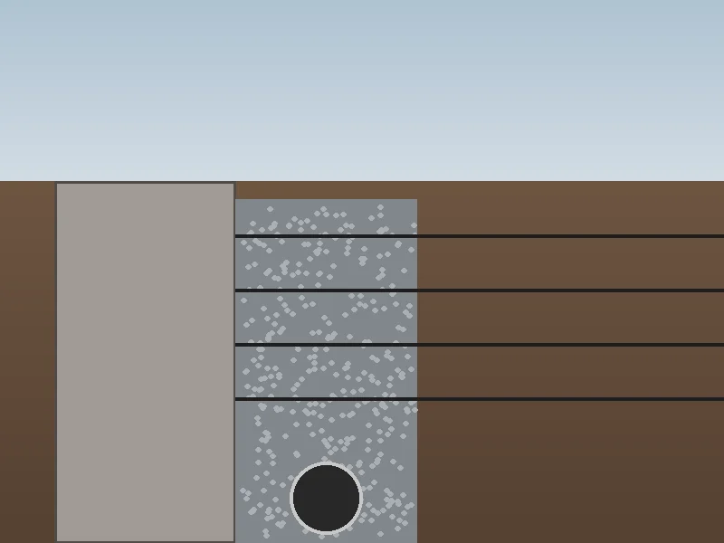 Geogrid soil reinforcement and perforated drain pipe installation behind structural retaining wall in Essex County